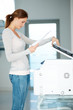 Pretty young businesswoman using Xerox machine Pretty young businesswoman using Xerox machine