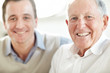 Closeup of father and son smiling together