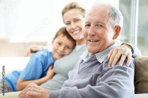 Photo: Senior man sitting with his daughter and grandson Senior man sitting with his daughter and grandson