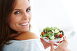 Young lady holding  bowl of vegetable salad