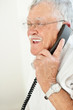 Closeup of relaxed aged man using  telephone