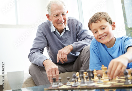 Photo: Grandfather and his grandson playing chess together Grandfather and his grandson playing chess together