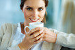 Lovely young lady drinking a cup of coffee
