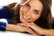 Beautiful woman lying down on floor and smiling