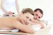 Smiling young couple having a stone massage Smiling young couple having a stone massage