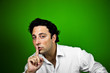 Hombre guapo pidiendo silencio sobre fondo verde
