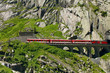 Red Train Goes Through Mountains