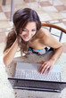 Foto: Young happy woman uses laptop computer Young happy woman uses laptop computer