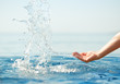 Hand splashing clean water on blue sea background. Hand splashing clean water on blue sea background.