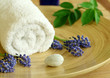 spa composition of towel, flowers and stone