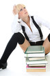 thoughtful schoolgirl sitting with books