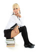schoolgirl sitting on stacked books