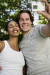Photo: Couple taking self portrait with digital camera Couple taking self portrait with digital camera