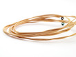 Coiled acoustic guitar strings on white background