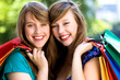 Happy young women with shopping bags