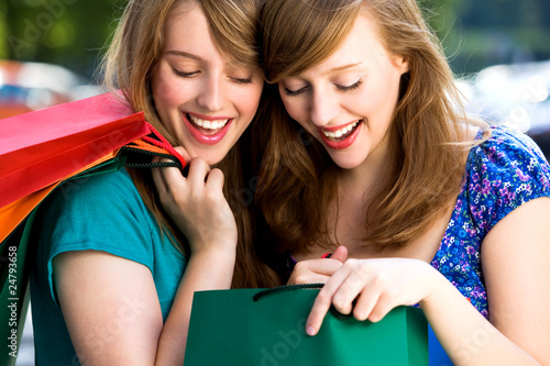Photo: Women looking in shopping bags Women looking in shopping bags