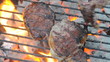 turning steaks on flaming charcoal briquette kettle grill turning steaks on flaming charcoal briquette kettle grill
