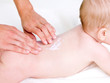 Mother massaging back of newborn baby Mother massaging back of newborn baby
