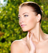 Woman stroking her fresh clean skin of face Woman stroking her fresh clean skin of face