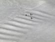 Three skiers skiing on artificial hillocks in Kitzsteinhorn Three skiers skiing on artificial hillocks in Kitzsteinhorn