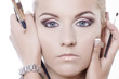 two hands with make-up brushes on model face two hands with make-up brushes on model face