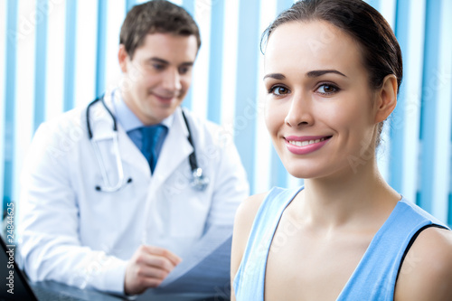 Photo: Happy female patient and doctor at office Happy female patient and doctor at office