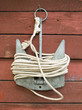 Anchor with rope on brown wooden wall background.