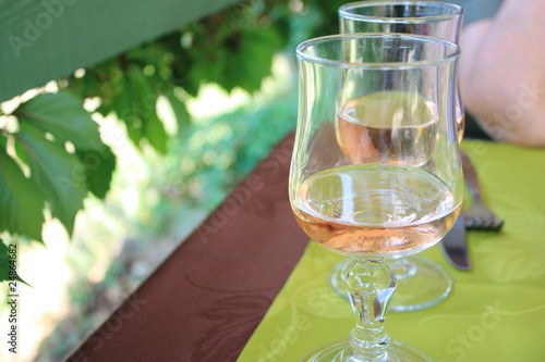 Photo: Two glasses of french wine on a restaurant's table. Two glasses of french wine on a restaurant's table.