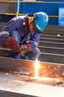 worker weld metal in factory and sparks