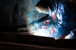 worker weld metal in factory and spark