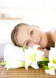 Portrait of a charming woman lying on a massage table smiling at Portrait of a charming woman lying on a massage table smiling at