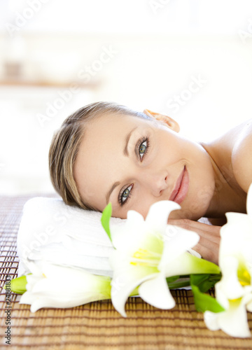 Photo: Portrait of a charming woman lying on a massage table smiling at Portrait of a charming woman lying on a massage table smiling at
