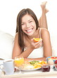 Woman eating breakfast in bed