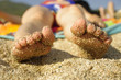 Woman's feet on sandy beach