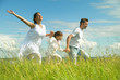 Happy family run on meadow