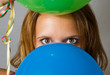 Junge Frau schaut durch Ballons