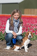 Girl with her dog on flower field