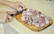 Women cuts raw meat