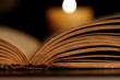 Candle and Opened Old Bible