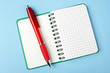 Opened notebook and red pen
