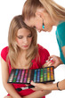 Make-up girl showing range of collors Make-up girl showing range of collors