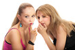 Two young woman sharing secret