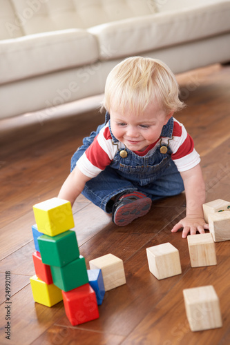 Young Boy Playing With Coloured Blocks At Home Young Boy Playing With Coloured Blocks At Home