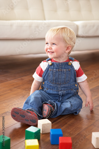 Young Boy Playing With Coloured Blocks At Home