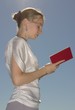 girl reading a red-covered book girl reading a red-covered book