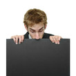 Businessman peeking at sign