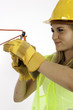 Foto: Construction Girl Cutting A Red Wire Construction Girl Cutting A Red Wire