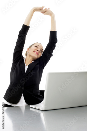Photo: tired young businesswoman with laptop on white background studio tired young businesswoman with laptop on white background studio
