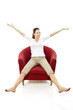 Photo: Young woman sitting on a chair on white background studio Young woman sitting on a chair on white background studio
