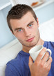 Portrait of a serious young man looking at the camera holding a Portrait of a serious young man looking at the camera holding a